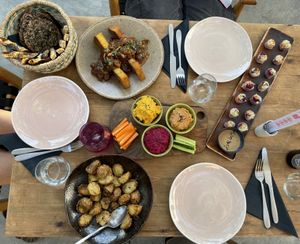 Basket of bread, crispy polenta with mushrooms, spring rolls, hummus variety and crispy potatoes  at Green Kukunari in Crete
