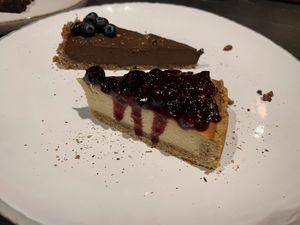 Front: Cheesecake with forest fruits Back: avocado and cacao raw slice  at Green Kukunari in Crete