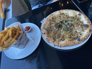 Mushroom pizza with vegan meat + fries  at MidiCi in San Mateo