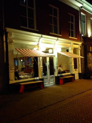 View from outside. Actually the name has been written on the windows and has been visible while looking below the sun protection. at Eetatelier in Arnhem