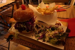 Burger with chickpea biscuit, salad and fries for 70 DH. at Corner Cafe in Marrakech