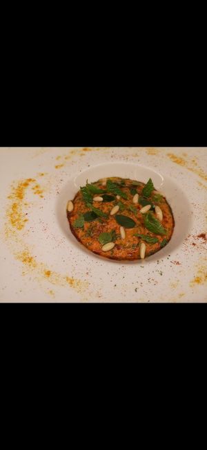 Crema di pappa al pomodoro con sopra basilico menta pinoli origano fresco at Marco Vitale Chef in Florence