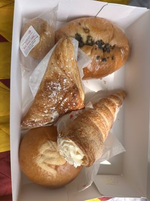 Upper left red bean cake, upper right spring onion bun, middle apple turnover, lower left lemon custard bun, lower right butter cream cone.   at Keefer Court in Eden Prairie