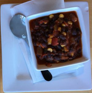 Cup of Vegan Black Bean Chili. Had a nice zing of spice/heat that complimented the Veggie Wrap well. Both together made a nice lunch. at Peoples Organic in Eden Prairie