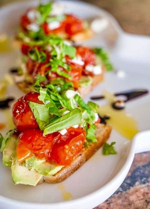 BRUSCHETTA - grilled sourdough, roasted cherry tomatoes, avocado, garlic, basil, balsamic reduction  at Sea Breeze Lounge in Hamilton