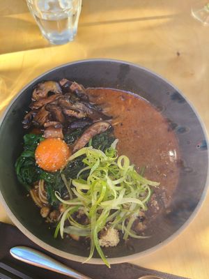 steaming hot bowl spicy tantanname ramen, sesame, szechuan pepper, spinach, tomato egg, spinach, and tofu oh my at Umami Ramen & Izakaya in Montreal