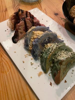 Gyoza platter, dough is hand dyed with all natural colorants. Filled with potato and soy (beet), Cashew cheese and greens (blue pea pod), Edamame and shiitake (spirulina) at Plant Based Sushi in Amsterdam