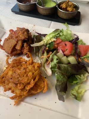On the top Pakora and below Oignon Bhaja (shared with my husband). Let them know your vegan because of the salad dressing.   at Le Penjab in Saint-malo
