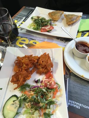 Starters: fried onion beignets and veggie samosas. The side salads contain mayo/garlic sauce. at Le Penjab in Saint-malo