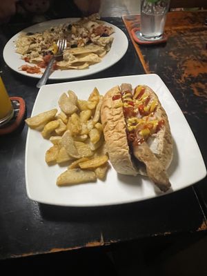 Dirty dog with fries (nachos from specials board in background)  at Filthy Vegan in Ho Chi Minh City