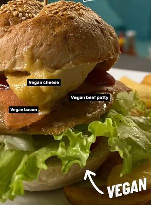 Homemade vegan bacon cheese burger with fries at Filthy Vegan in Ho Chi Minh City