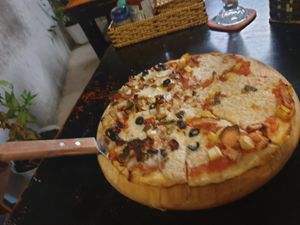 Pizza half and half veggie and 'meat'  6/10 toppings great base left more to be desired at Filthy Vegan in Ho Chi Minh City