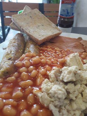 Vegan Full English breakfast! 2 vegan sausages, 2rashes of vegan bacon, Heinz baked beans, 1hash brown, fried mushrooms, fried tomatoes, scrambled tofu, 2 slices of multi grain bre at Filthy Vegan in Ho Chi Minh City