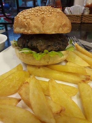 Big filthy blackbean burger with home cooked fries. Comes with 3 condiments. Garlicky mayo, Italian tomato sauce and mustard. at Filthy Vegan in Ho Chi Minh City