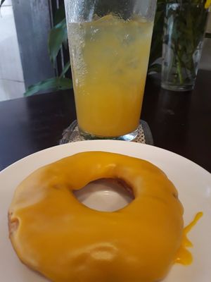 Orange doughnut with orange juice at Filthy Vegan in Ho Chi Minh City