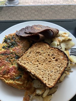 Chicklette (chickpea omelette), home fries, toast, and bacon at How Delish HD in West Orange
