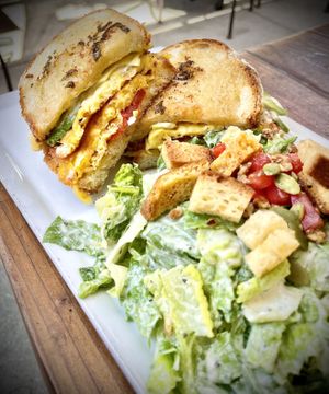 The delicious ,breakfast sandwich with a Caesar salad  at SunCafe in Studio City