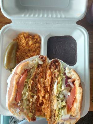 Cowboy torta with a side of beans and rice  at Nuno's Tacos & Vegmex Grill in Dallas