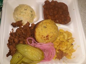 BBQ plate with mac n cheese, baked beans, potato saladn cornbread. This was just okay, and it is offered seasonally. at Nuno's Tacos & Vegmex Grill in Dallas