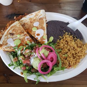 Quesadilla w the el pastor protein (also has pineapple in it) with a few sauces at Nuno's Tacos & Vegmex Grill in Dallas