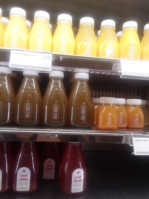 Orange juice, orange mango juice, a green juice, cayenne shot, ginger shot and lemonades. at CLT - Pret A Manger - CC in Charlotte