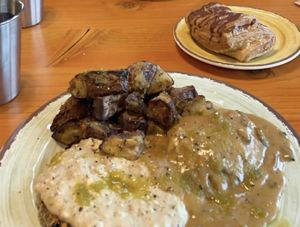 biscuits and gravy with taters and then a chocolate croissant.  at The Park Side Cafe in Olympia