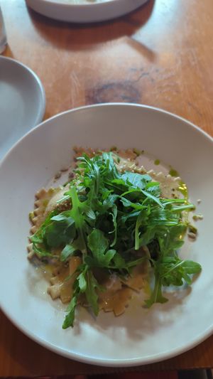 The starter was roasted rainbow carrots (toum, zhug, pistachio dukkah). The entree was ravioli (cashew ricotta, pesto, dukkah, arugula). at The Park Side Cafe in Olympia