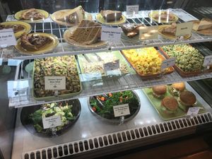 Mix of salad, pies, cakes, and lions mane crab cake sandwiches  at The Park Side Cafe in Olympia