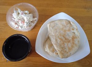 Lemon water, potato salad, khuushuur at Loving Hut - Ikh delguur in Ulaanbaatar