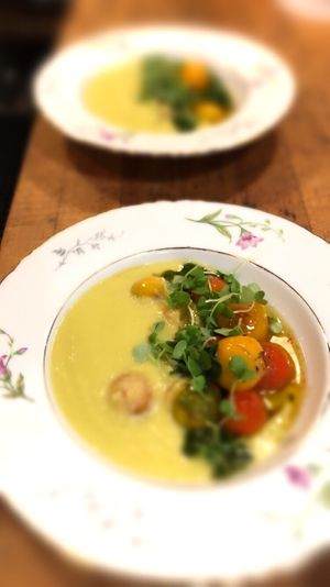 Warm green zebra tomato soup with cherry tomatoes  at Local Vegan in Seattle