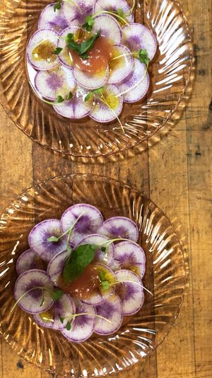 Dialing radish carpaccio with quince preserves  at Local Vegan in Seattle
