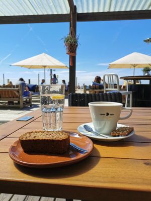 Banana bread & cappuccino w/ oatmilk at Beachclub Copacabana in The Hague