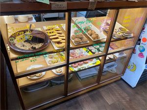 The green circles I added indicate vegan items. This was their dessert car featuring vegan olive oil cake, ginger cookies, and chocolate chip cookies.  at Wild Grocery & Cafe in Manzanita