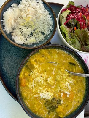 Indian green curry with rise and side salad.  at The Heart of Joy in Salzburg