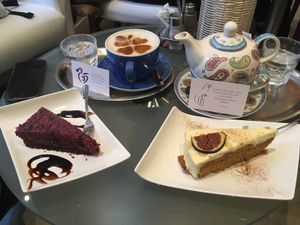 Raw vegan cake, (vegetarian) carrot cake, tea and oat milk cappuccino at The Heart of Joy in Salzburg