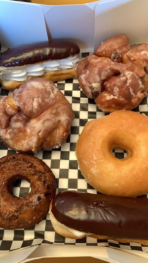 Eclairs, Apple fritters, plain glazed and blueberry maple donuts at Mmm Donuts in Barrie