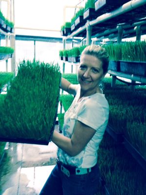 Julie showing off her growing skills. Nice. Nice. at Universal Living Sprouts in West Palm Beach