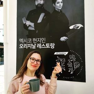 The owners have a poster outside. They serve coffee. I like to drink it on the patio. at Ay Mamita in Jeonju