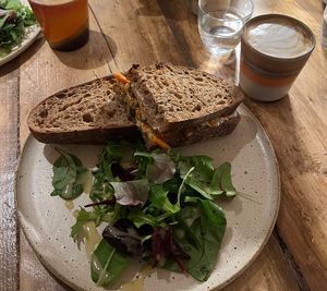 Kimchi tofu roasted sandwich and oat flat white   at The Hairy Barista in Totnes