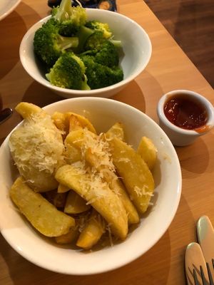 A side of steamed broccoli and some chips with shredded parmesan. Vegan, of course! at Luna's Vegan Corner in Cardiff