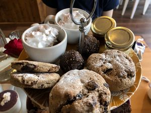 Cookies, biscuits (or scones?) chocolate pudding with whipped cream on top, jam, and margarine. at Luna's Vegan Corner in Cardiff