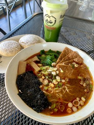 Spicy miso ramen with no egg and sweet tofu, iced matcha with oat milk and red beans pancakes    at Cravings Deli in Portage