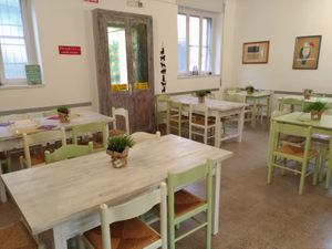 Two dining rooms at Circolo Arci Impatto Zero in Pavia