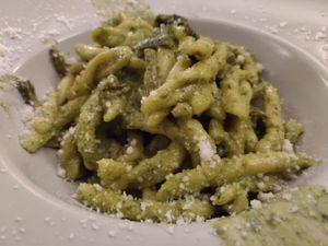 Traditional Italian cuisine: Strozzapreti pasta with pesto and zucchini with three colors at Circolo Arci Impatto Zero in Pavia