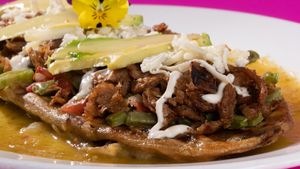 Fried corn dought With beans and avocado leaves, on green sauce. at Veggicano Plant Based in Mexico City