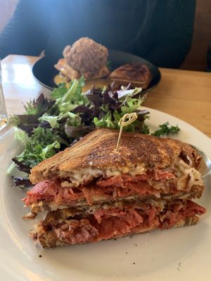 Pastrami sandwich 👌🏼💋 and cauliflower “chicken” & waffle in the bg at Watercourse Foods in Denver
