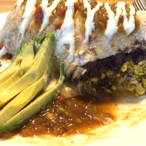 BREAKFAST BURRITO (Refried black beans and your choice of home fries, sweet potatoes, or rice, wrapped in a tortilla and smothered with gravy or green chili) at Watercourse Foods in Denver