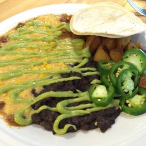BREAKFAST BURRITO (Refried black beans and your choice of home fries, sweet potatoes, or rice, wrapped in a tortilla and smothered with gravy or green chili) at Watercourse Foods in Denver