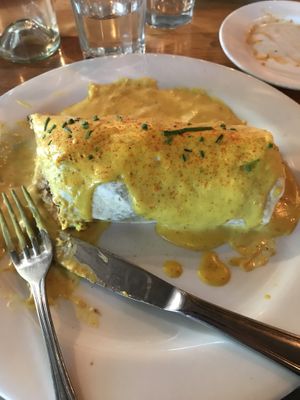 Breakfast burrito with cheese sauce at Watercourse Foods in Denver