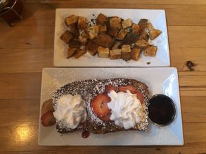 French toast with whip cream, strawberries, and diced potatoes at Watercourse Foods in Denver